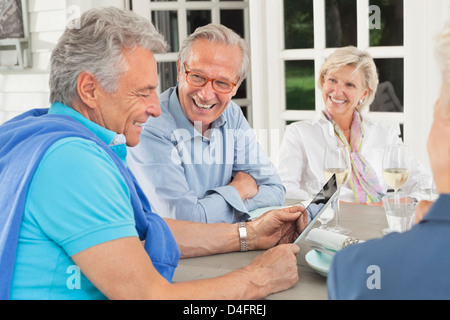 Friends using digital tablet together Stock Photo