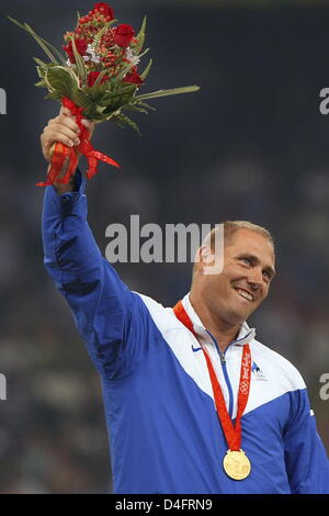 Gold medalist Gerd Kanter of Estonia celebrates on the podium during the medal ceremony for the Men`s Discus Throw Final in the National Stadium during the Beijing 2008 Olympic Games in Beijing, China, 20 August 2008. Photo: Jens Buettner dpa ###dpa### Stock Photo