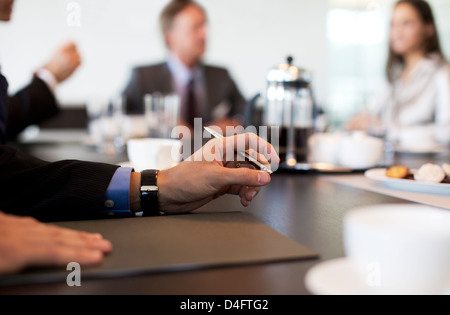 Close up of businessman's hand in meeting Stock Photo