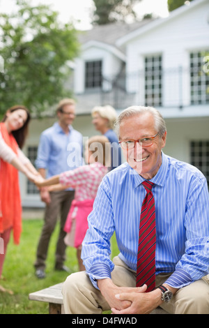 Man smiling outside house Stock Photo