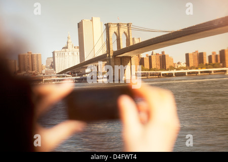 Hands taking picture of urban bridge and cityscape Stock Photo