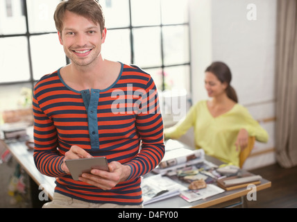 Smiling man using digital tablet Stock Photo