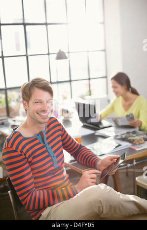 Smiling man using digital tablet Stock Photo