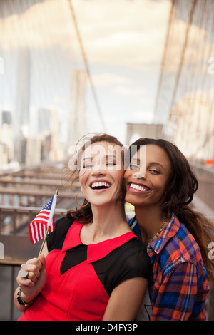 Smiling women waving American flag