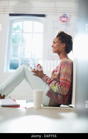 Businesswoman making notes in office Stock Photo