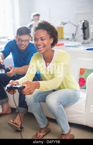 Couple playing video games together Stock Photo