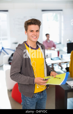 Man wearing headphones in office Stock Photo