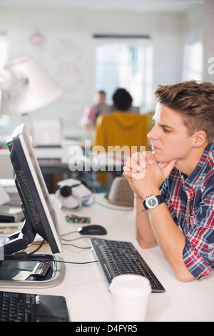 Businessman working at computer at desk Stock Photo