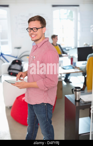 Businessman using digital tablet in office Stock Photo