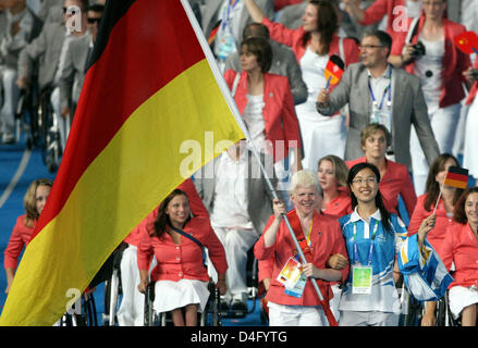German goalballer Conny Dietz (C) is the flagbearer for the German team at the opening ceremony of the 2008 Paralympic Games in the National Stadium in Beijing, China, 06 September 2008. 171 German athletes compete in the Paralympic Games two weeks after the Olympic Games. Visually handicapped Dietz competes at her sixth Paralympic Games, in 1996 she won a gold medal in Atlanta, US Stock Photo