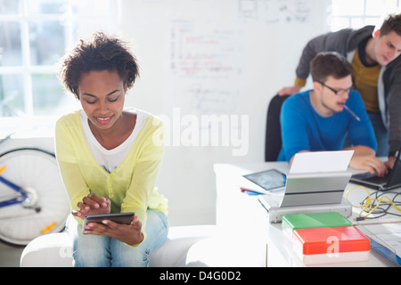Businesswoman using digital tablet in office Stock Photo