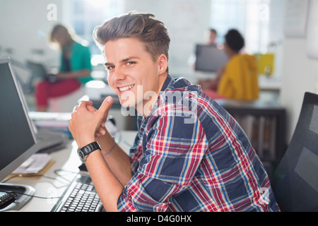 Businessman smiling at desk Stock Photo
