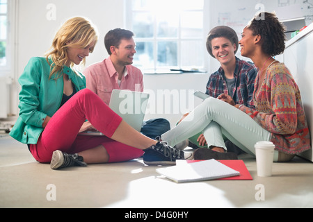 Business people talking on floor in office Stock Photo