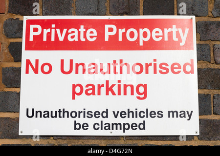 No parking sign threatening wheel clamping Stock Photo