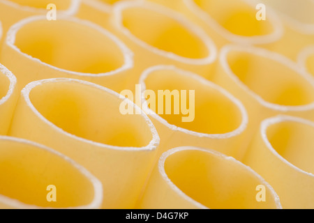 dried cannelloni background or yellow pasta texture Stock Photo