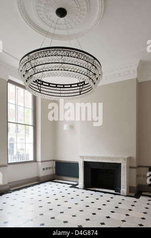 empty room with large chandelier and fireplace Stock Photo