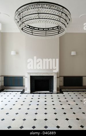 empty room with large chandelier and fireplace Stock Photo