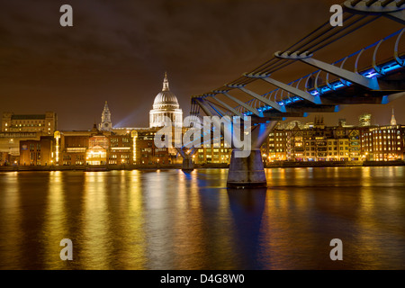 A night shot of St. Paul's Cathedral and the Millennium Bridge in London from the Jubilee Walk. Stock Photo