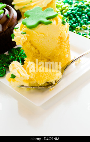 White chocolate cupcakes with white chic mousse and white buttercream frosting for St. Patrics Day. Stock Photo