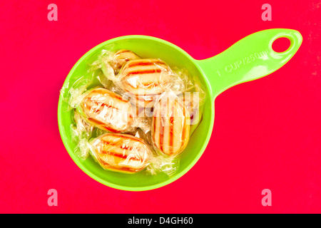 Humbug sweets on a vibrant pink background Stock Photo