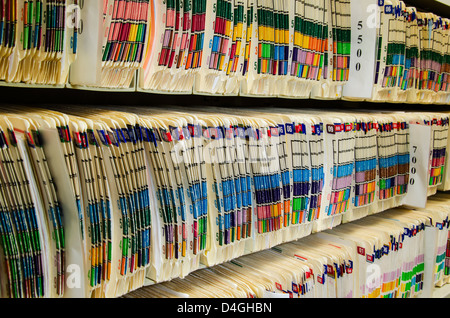 Shelves filled with colorfully labeled medical files Stock Photo