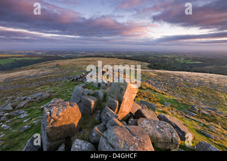 Early morning autumn sunlight lights up the granite rocks of Belstone Tor, Dartmoor, Devon. Stock Photo