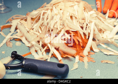 Potato and carrot peelings on a worktop Stock Photo