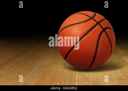 Basketball on a hardwood court floor as a sports and fitness symbol of a team leisure activity playing with a leather ball dribbling and passing in competition tournaments. Stock Photo