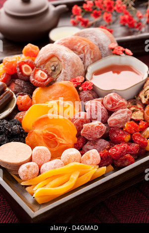 Various Chinese traditional preserved fruits and tea Stock Photo