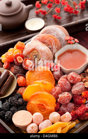 Various Chinese traditional preserved fruits and tea Stock Photo