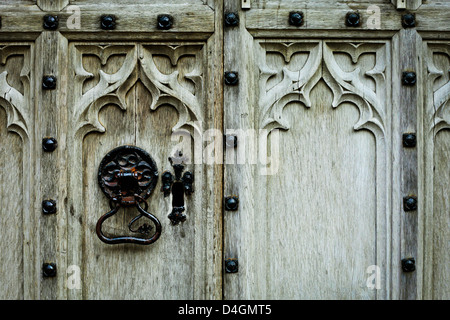 Metal door handle on a medieval wooden door Stock Photo