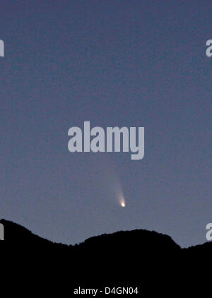 Las Vegas, Nevada, USA. 13th March 2013.  The comet PanSTARRS, at twilight is seen over the Spring Mountains range on March 13, 2013 in Las Vegas, Nevada. Officially known as C/2011 L4, the comet got its name after being discovered by astronomers using the Panoramic Survey Telescope & Rapid Response System (Pan-STARRS) telescope in Hawaii in June 2011. (Credit Image: © David Becker/ZUMAPRESS.com)  Credit:  ZUMA Press, Inc. / Alamy Live News Stock Photo