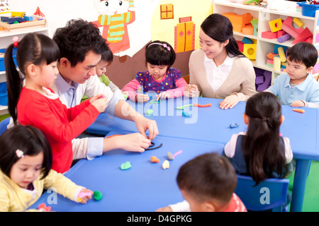 Kindergarten kids playing with plasticine Stock Photo