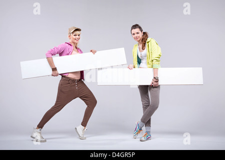 Relaxed fit girlfriends with empty boards Stock Photo