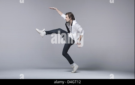 Handsome young man in acrobating pose Stock Photo