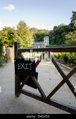 Exit sign on gate with church in background Stock Photo