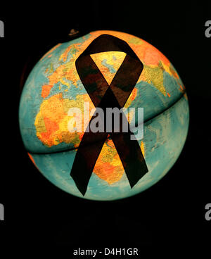 (dpa file) - An AIDS ribbon seen on an illuminated globe in Frankfurt Oder, Germany, 29 November 2006. United Nations aids programme UNAIDS states in its latest report, published in New York, 29 July 2008, that the AIDS epidemic remains at an unacceptable high level. At the end of 2007 some 33 million people were infected with the AIDS virus HIV worldwide. Photo: Foto: Patrick Pleu Stock Photo