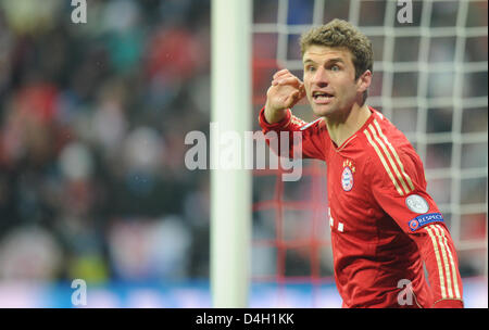Munich, Germany. 13th March 2013. Munich's Thomas Mueller gestures during the UEFA Champions League soccer round of sixteen between FC Bayern Munich and Arsenal FC at Fußball Arena München in Munich, Germany, 13 2012. Photo: Marc Müller dpa /Alamy Live News Stock Photo
