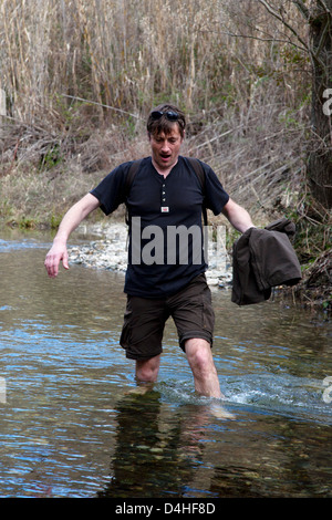 Man walking across shallow river nr.Falset, Priorat Stock Photo