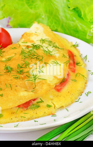 Omelet with herbs and vegetables on the plate Stock Photo