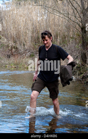 Man walking across shallow river nr.Falset, Priorat Stock Photo