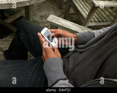Close Up Of Mixed Race Man Texting On Samsung Touch Screen Mobile Phone Stock Photo