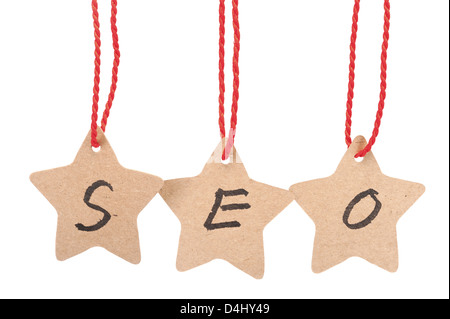 SEO word spelled with paper stars are hung by ropes, isolated against white background Stock Photo