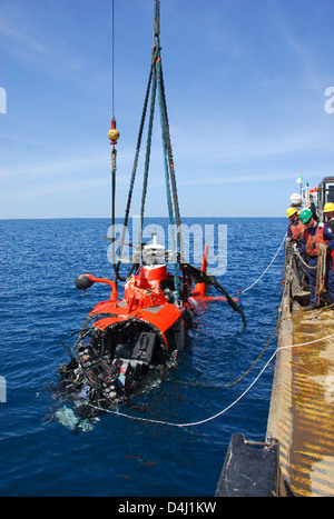 A Coast Guard helicopter performs a rescue operation, saving sailors ...