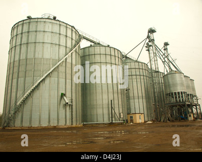 work-site with industrial silos on a rainy day Stock Photo
