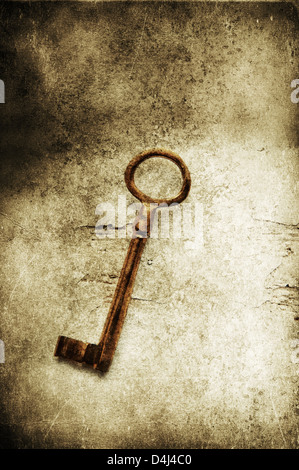 Old brass key on textured background Stock Photo