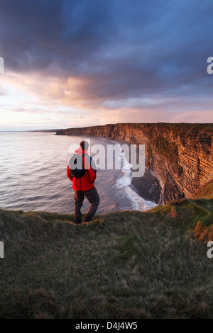 Walker at Nash Point on the Wales Coast Path. Glamorgan Heritage Coast. Vale of Glamorgan. Wales. UK. Stock Photo