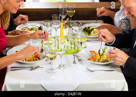 Family, mother and father with adult children and daughter or son in law –fine dining in nice restaurant or hotel Stock Photo