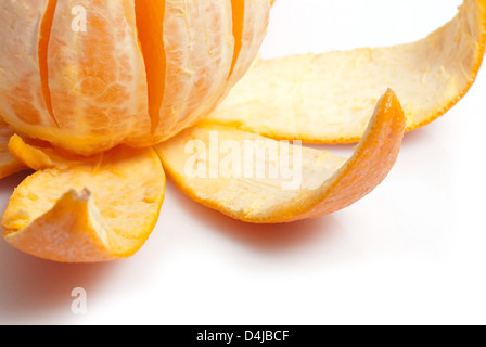 Unpeeled orange against white background Stock Photo