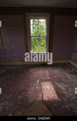 A window in an abandoned house with sunlight streaming through. Stock Photo